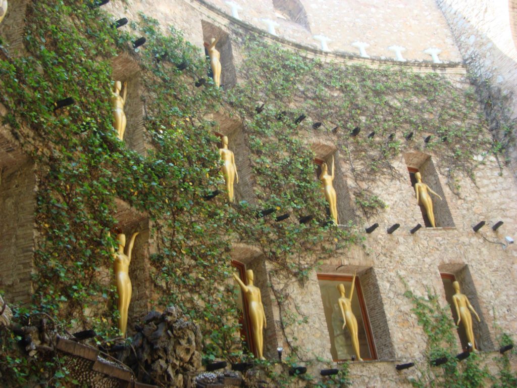 The golden Oscar statues with upraised arms in the Dali Museum