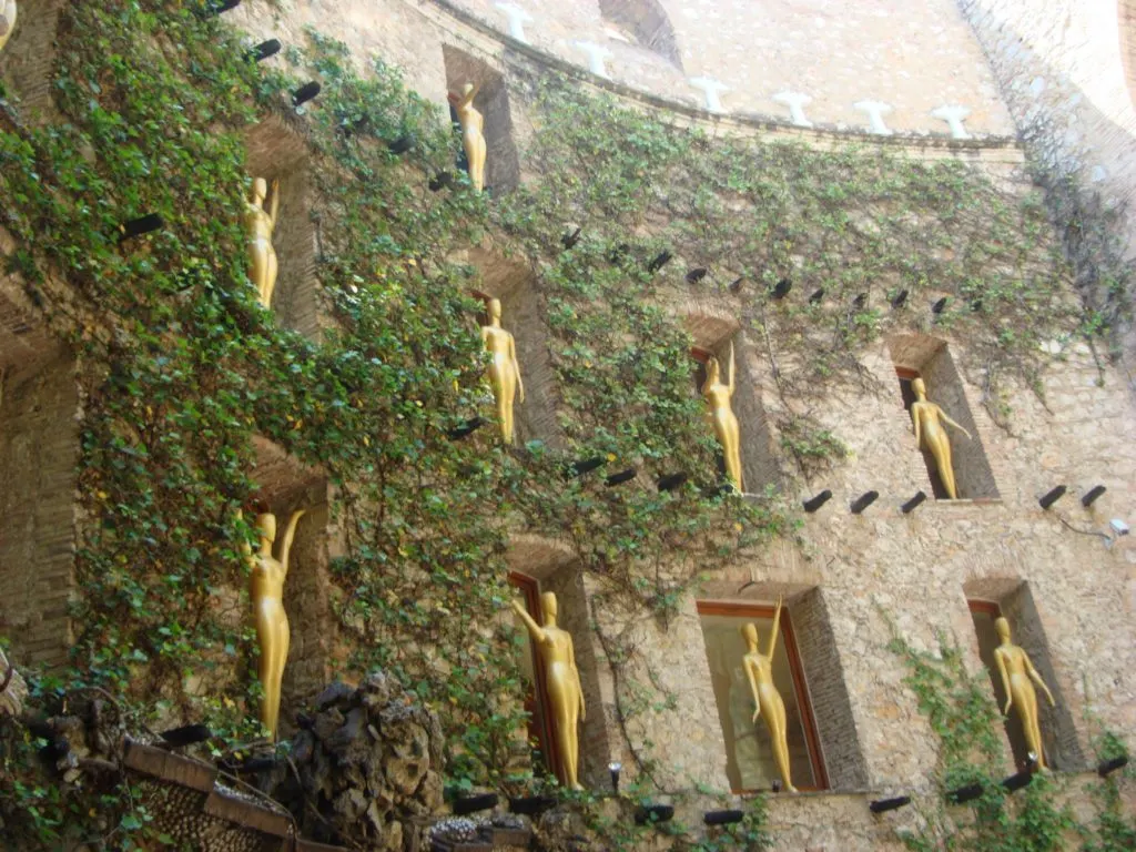The golden Oscar statues with upraised arms in the Museum's courtyard The golden Oscar statues with upraised arms in the Dali Museum