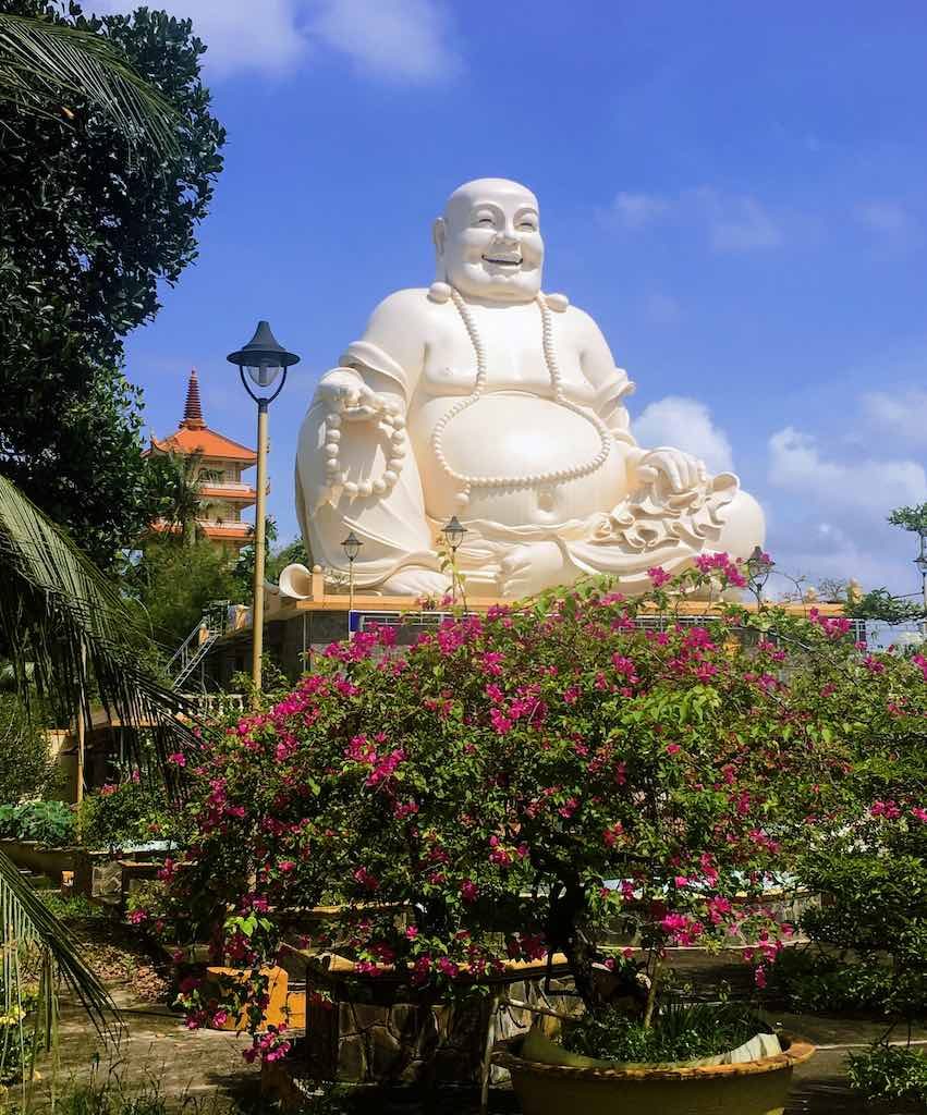 Skinny Buddha vs Fat Buddha in Vietnam I Laughing Buddha statue at Vinh Trang Temple in Vietnam by WorldTravelConnector.com  I buddha laughing I hotei buddha I  laughing buddha I statue of laughing buddha I  laughing buddha statue I happy buddha statue I budai I Chinese Jolly  Buddha 