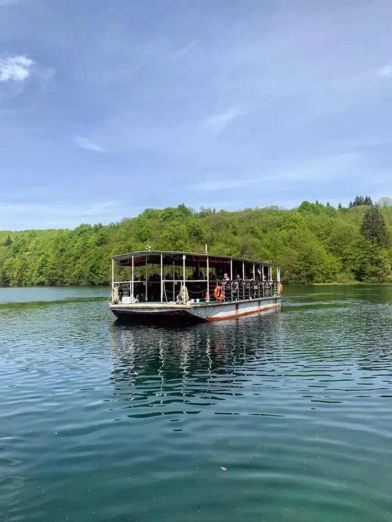 How to Visit Plitvice Lakes National Park (2023) 14 A ferry boat on Kozjak Lake on my visit to Plitvice Lakes National Park in Croatia