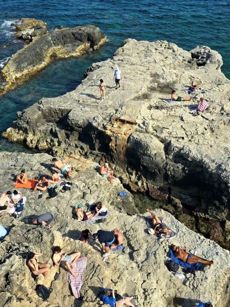 Bathing below the walls of Ortygia, Syracuse Italy