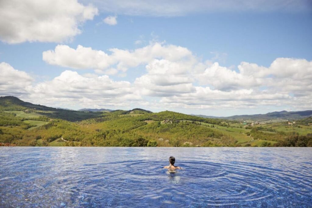 Infinity pool of Castello di Casole, A Belmond Hotel, one of the best castle hotels in Tuscany